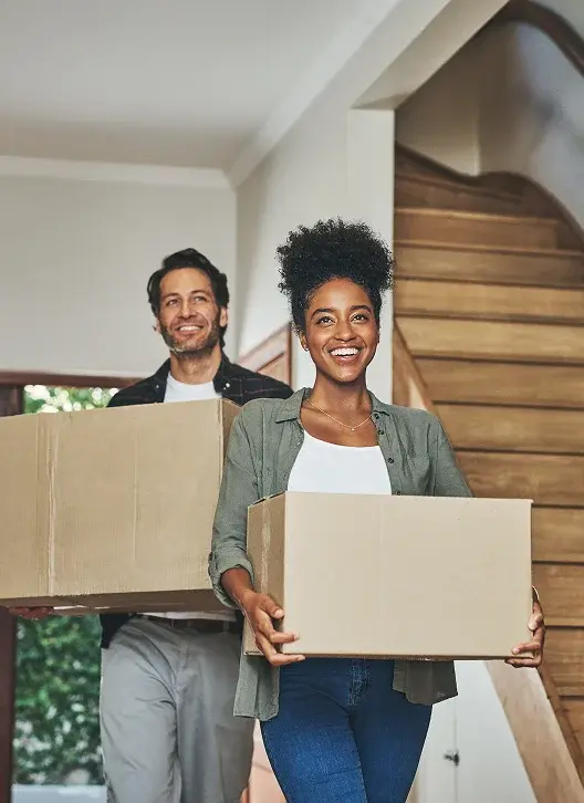 Happy couple with moving boxes planning their relocation to Panama